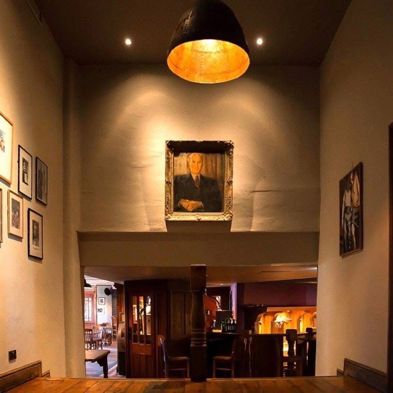 Artwork and warm lighting inside The Charles Bradlaugh